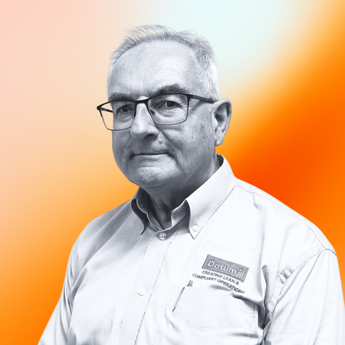 Bill Swindell, Compliance, with a black-and-white filter. The background is an orange gradient.