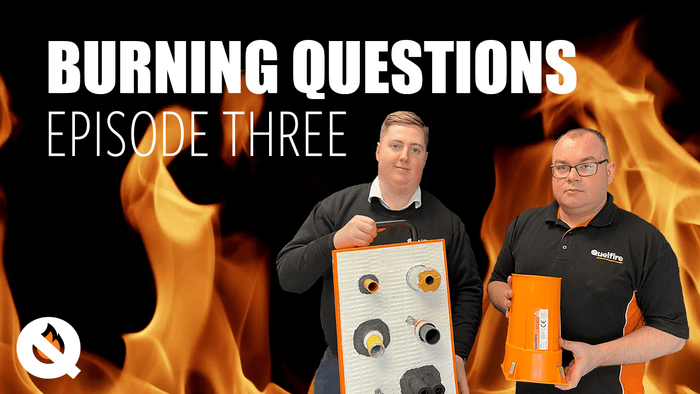 Video thumbnail with flame background and Quelfire logo in the corner, featuring Glenn Hutchins and Alec Purdie from the technical team at Quelfire, both in black Quelfire uniform. Glenn is holding a display board of different installs of pipes. Alec is holding a QuelCast. The title of the video is Burning Questions Episode Three.