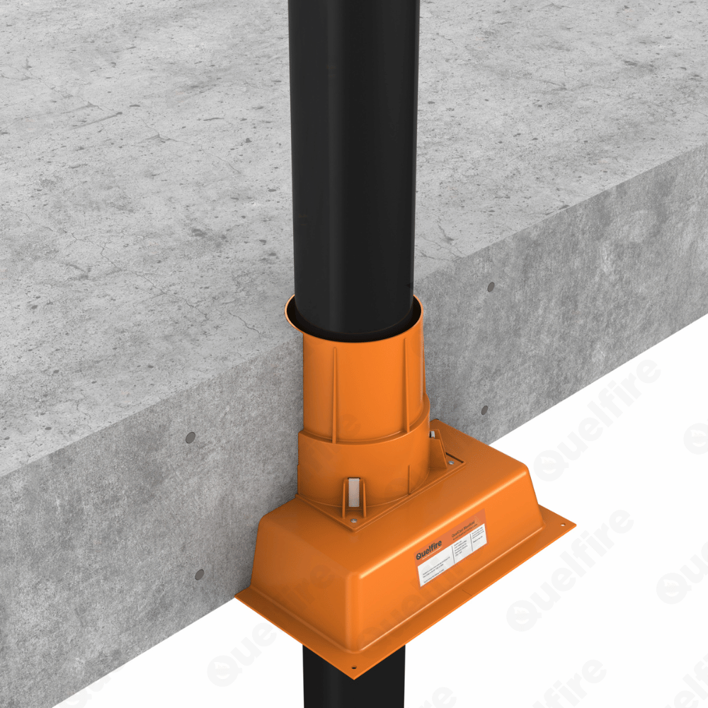 QuelCast Fire Collar with manifold on the bottom installed with a plastic pipe penetrating a concrete floor.