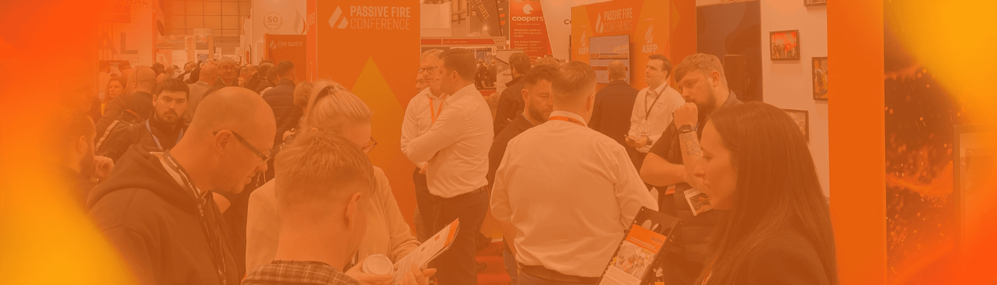 An orange gradient screen with the Quelfire team talking to customers at an exhibition.