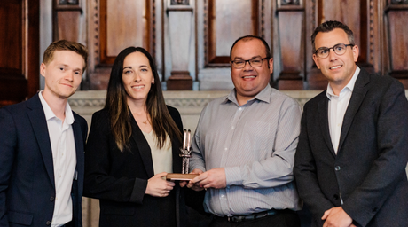 Alec Purdie and Chloe Miller, from the technical team, on stage with Willmott Dixon representatives. 