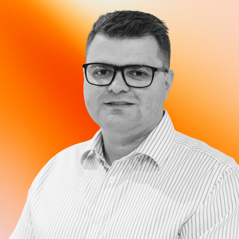 Darryl Wells, R&D/Commercial, with a black-and-white filter. The background is an orange gradient. 