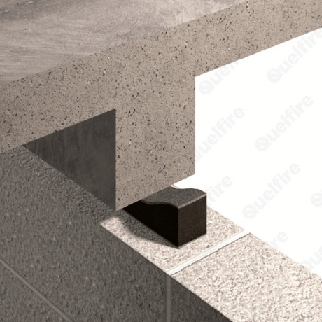 Concrete walls intersect at a right angle, forming a corner. A black block of Quelfire Intufoam is positioned between them, showing a structural detail. Neutral tone.