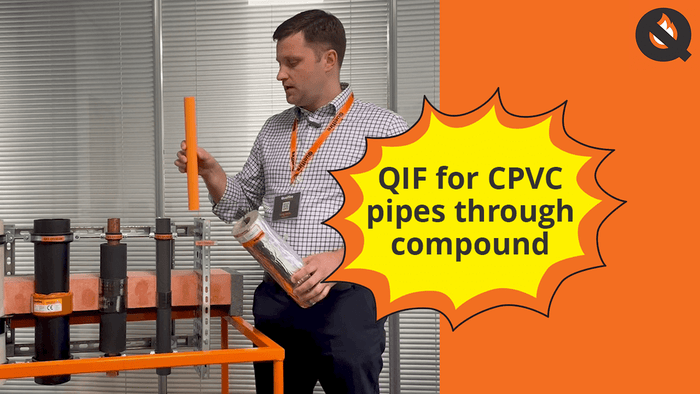 Person holding a QIF for CPVC pipes with an orange background and Q logo.