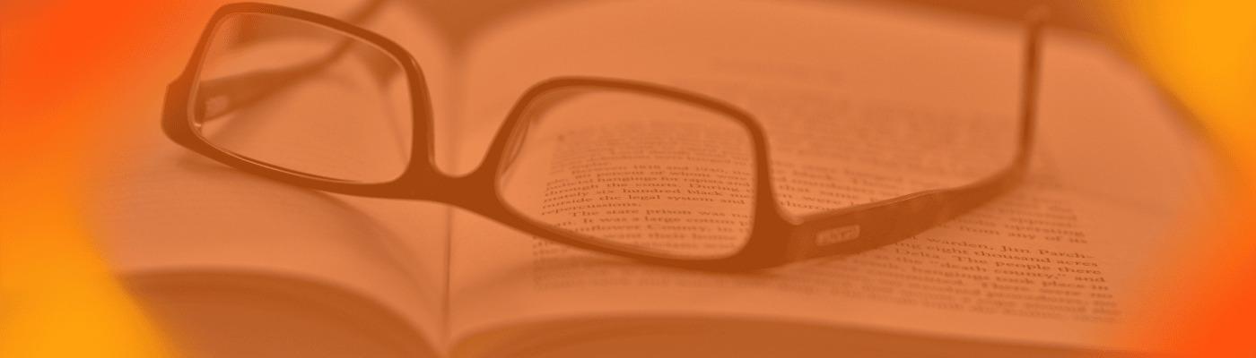 An orange gradient screen with an open book and a pair of reading glasses on top. 