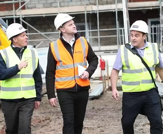 3 guys in high viz jackets and hard hats (featuring Craig Wells sales director) on a site visit.
