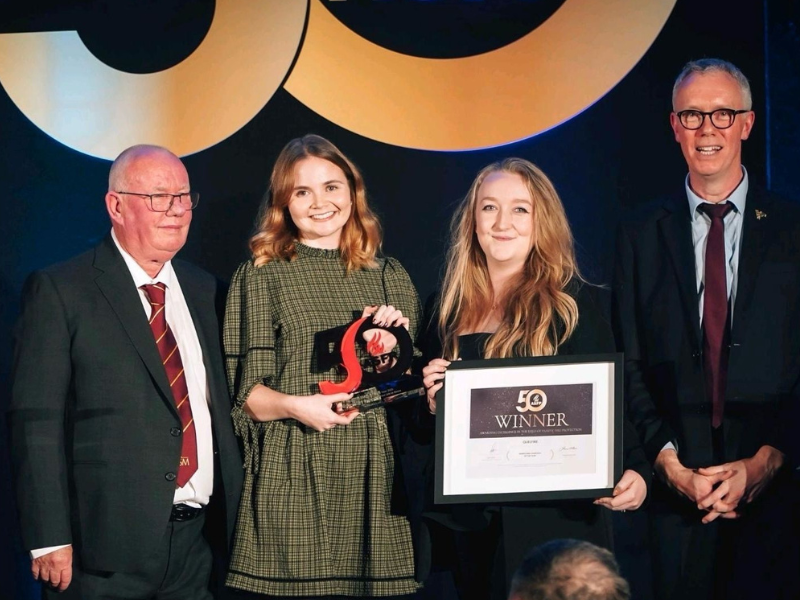 Rebecca Croton and Hayley Clay of Quelfire's Marketing team, accepting an award for Best Marketing Campaign of the Year at the ASFP Awards in 2025.